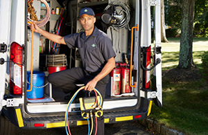 Wallace service tech in front of truck