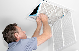 Man changing HVAC filter