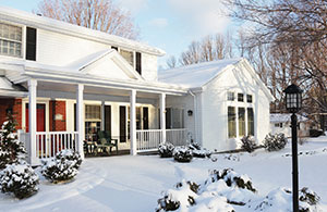 House and yard covered by snow